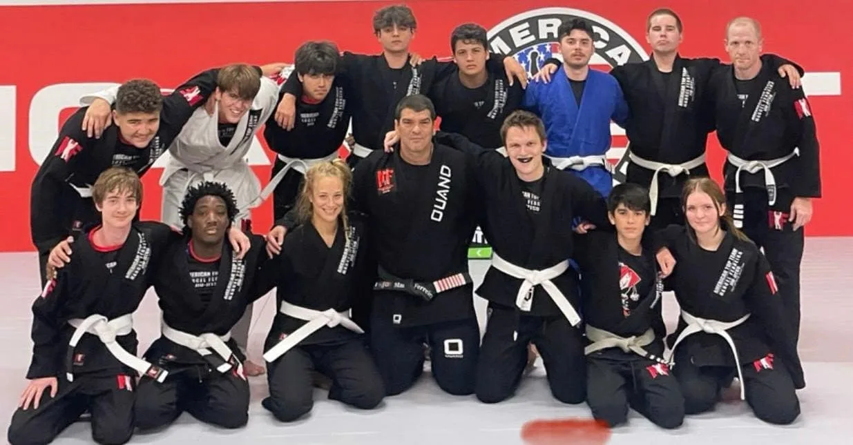 Adult students in BJJ standing together in a supportive training environment