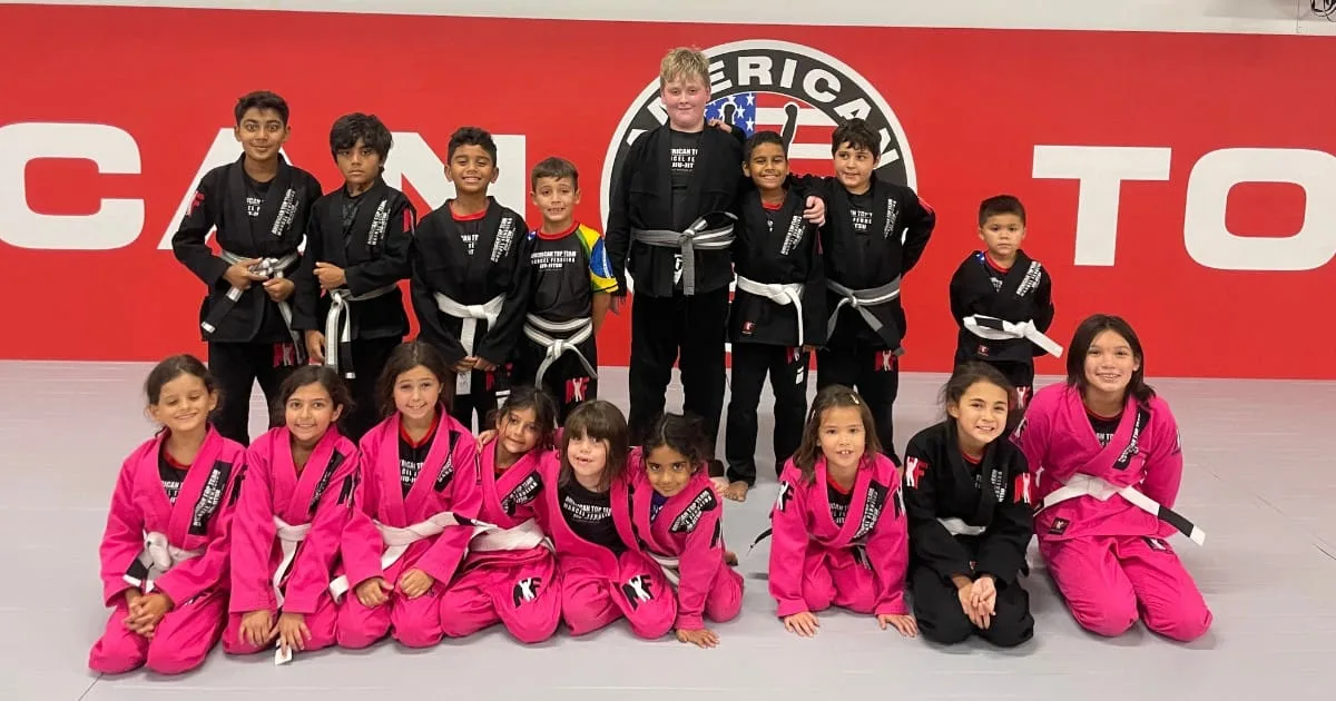 kids martial arts students smiling and showing confidence on the mats
