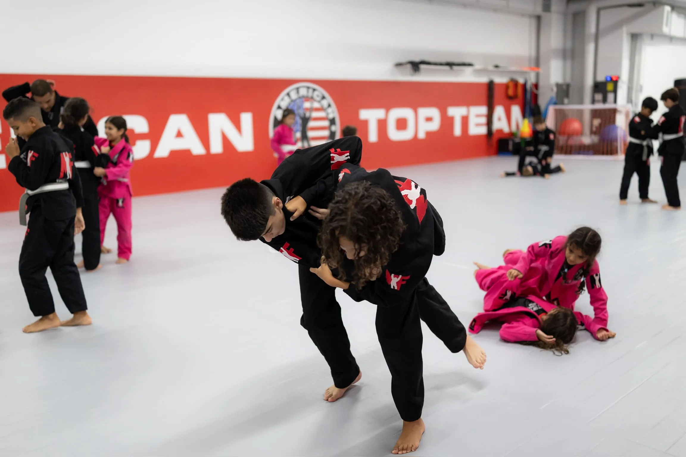 bjj practitioners teach kids through sparring sessions