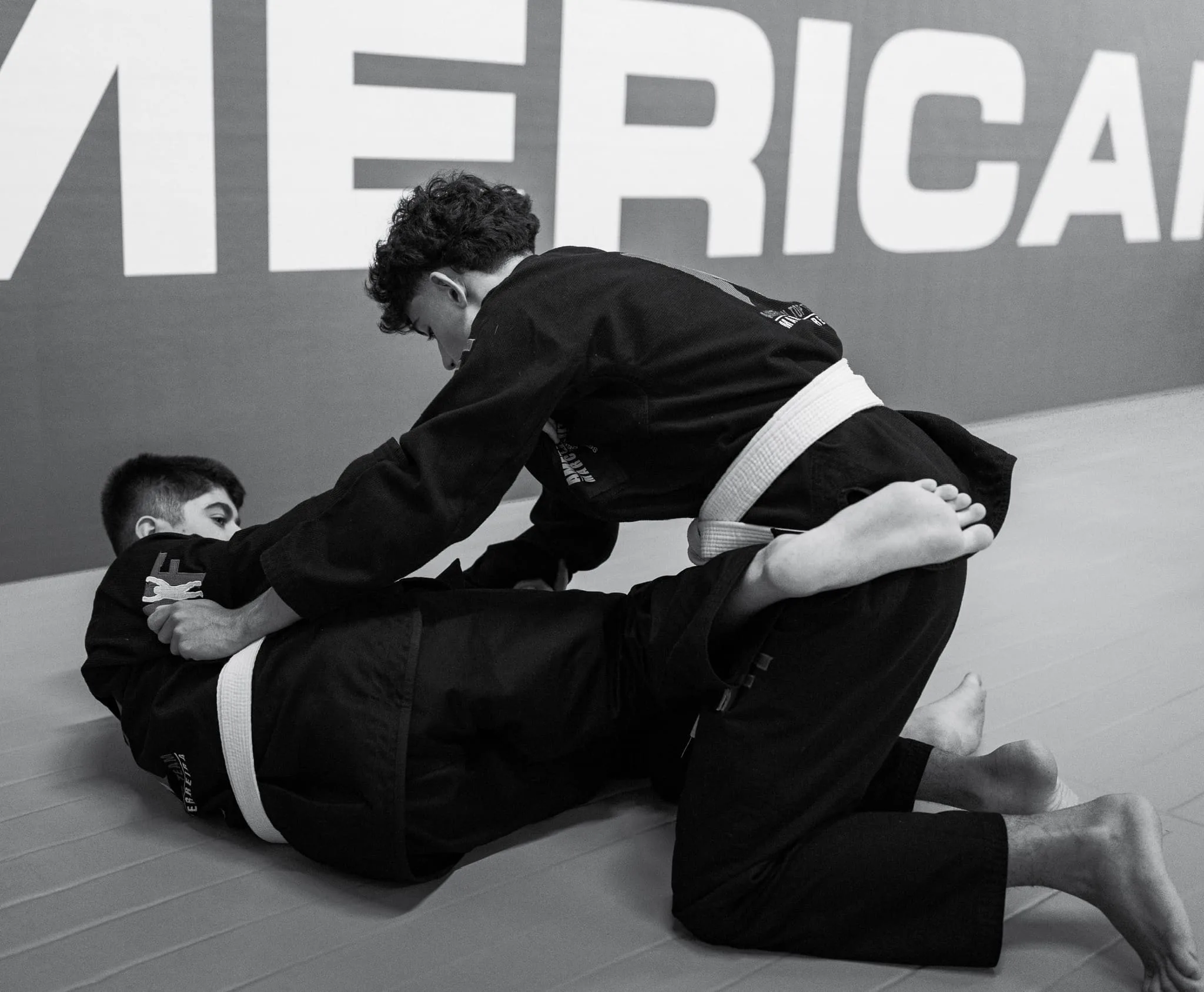 Teens showing BJJ transitions during a training session