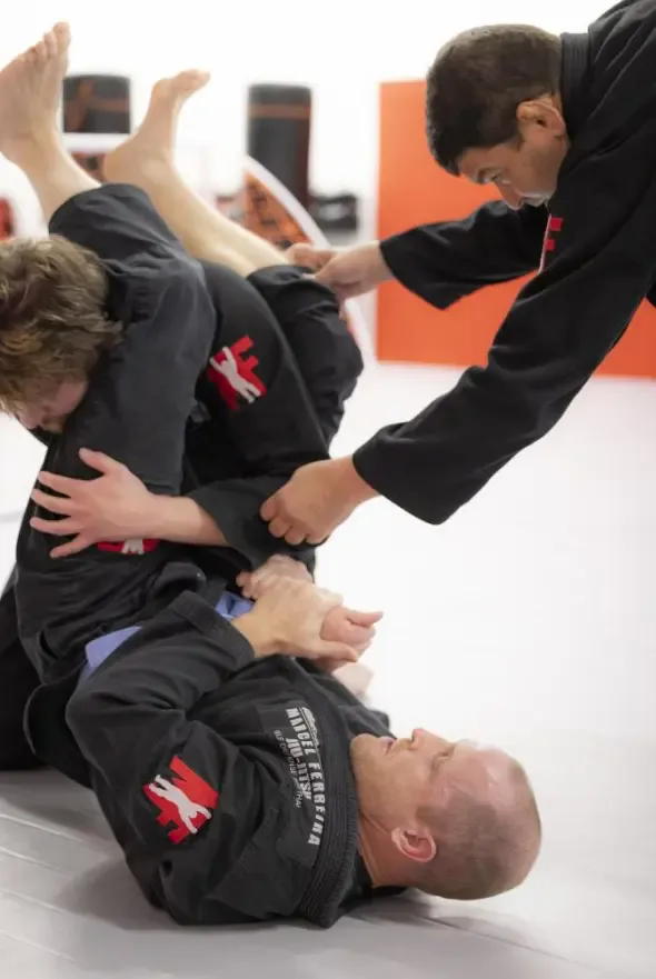 Adult demonstrating jiu jitsu moves during training