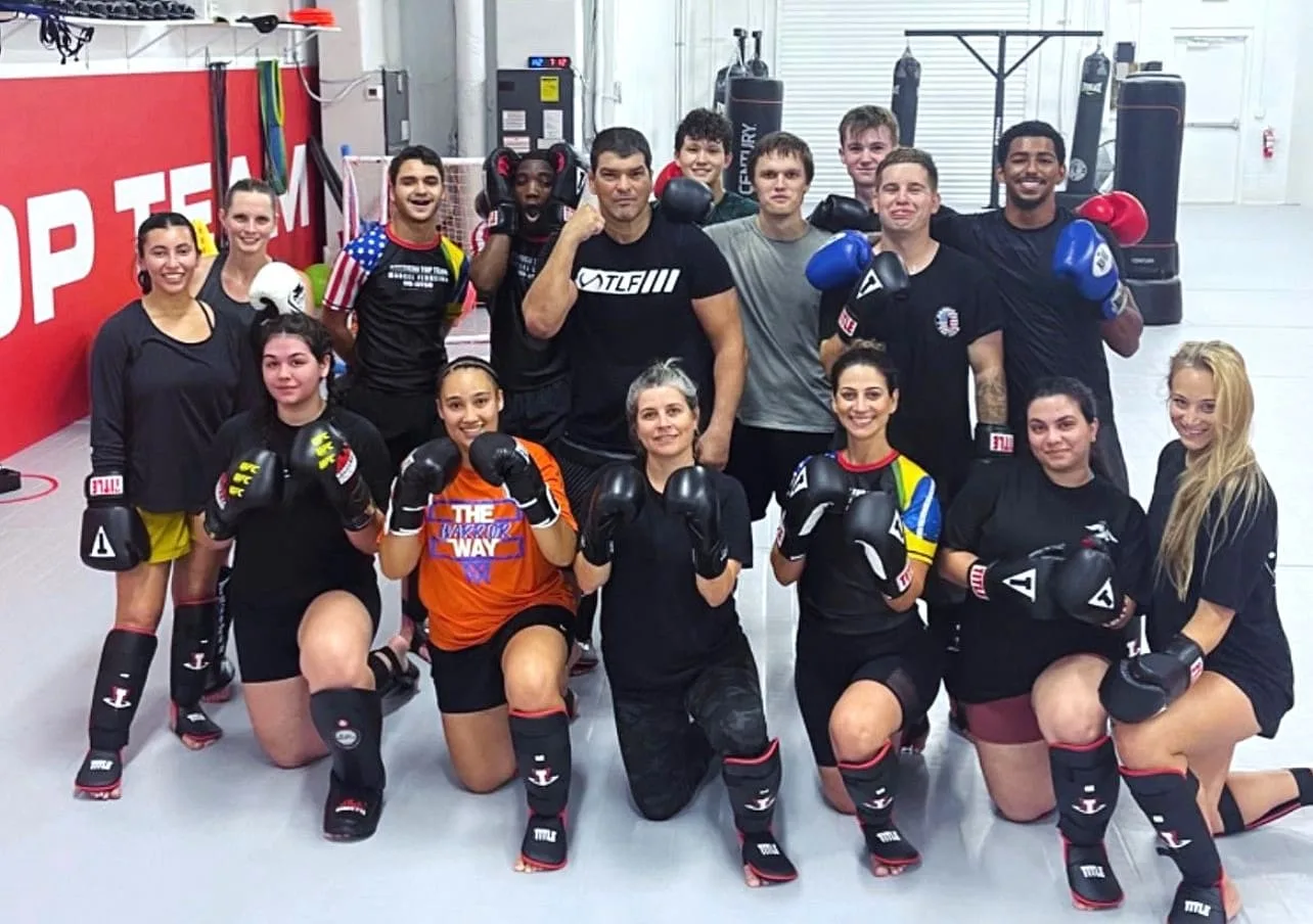 Teens wearing gloves and shin guards after martial arts workout