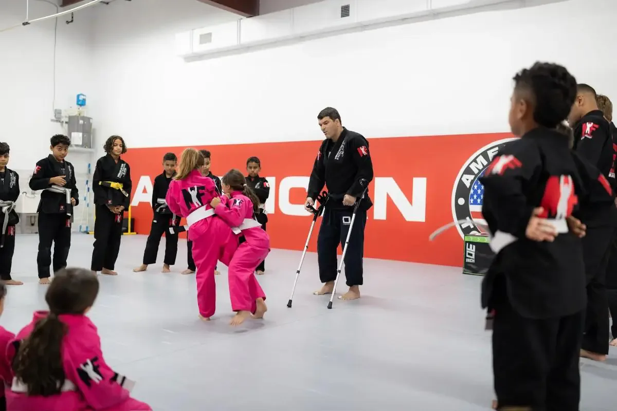 Kids martial arts class practicing partner grappling drill