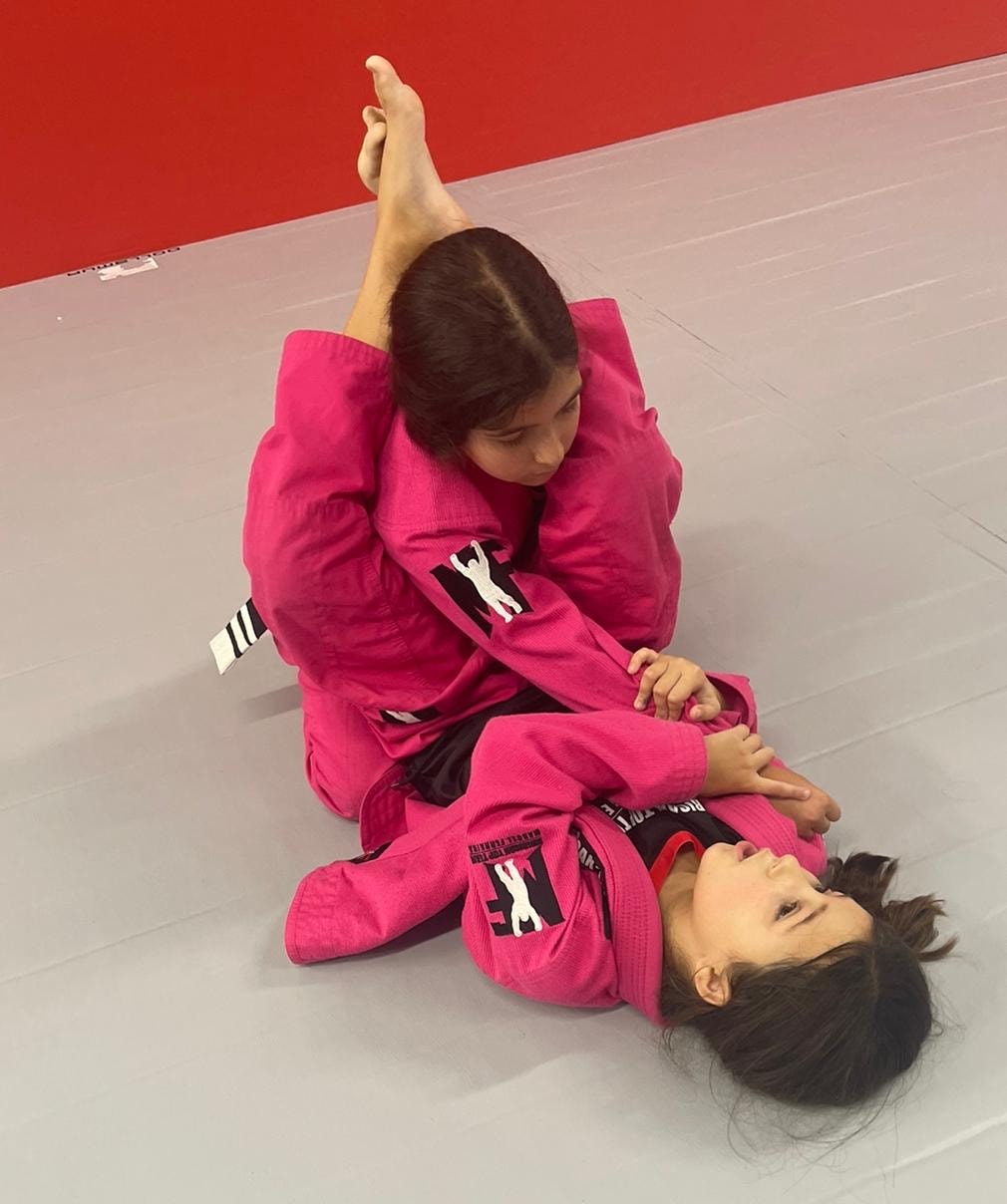 Learning jiu-jitsu with assistant instructors helps students improve their grappling skills.